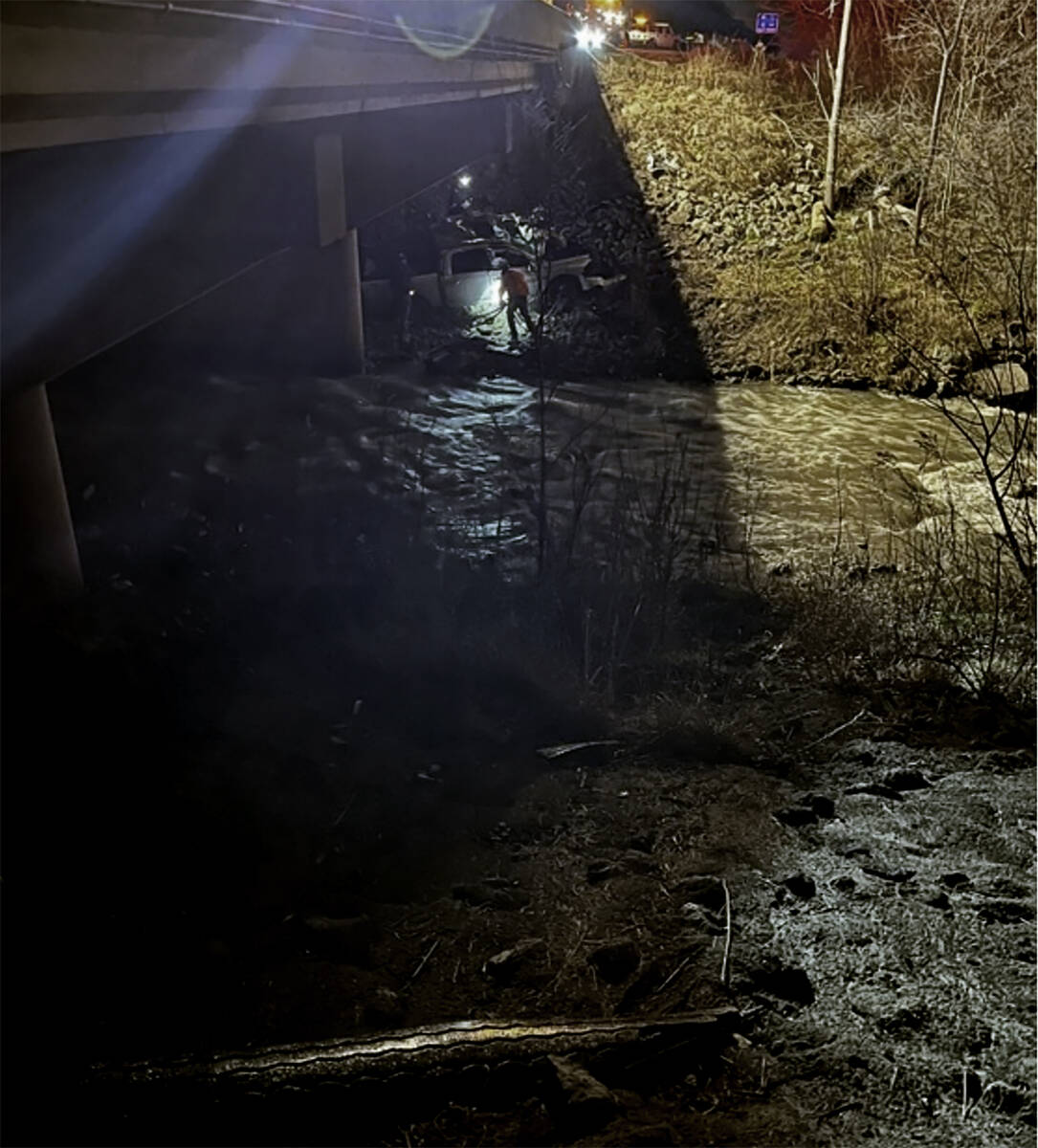 This photo provided by the Indiana State Police, police rescue a man after finding his damaged ...