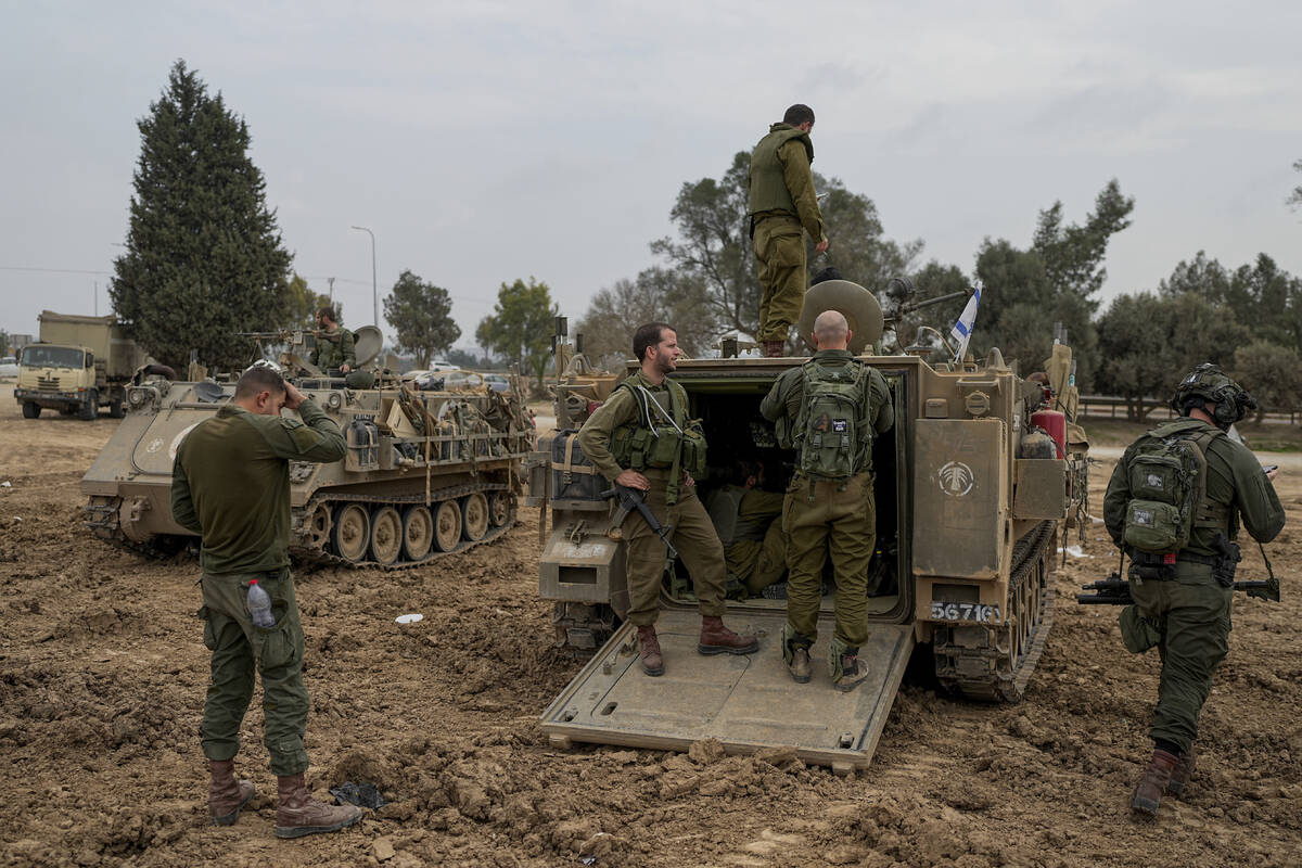 Israeli soldiers are seen at a staging area near the Israeli-Gaza border, in southern Israel, T ...