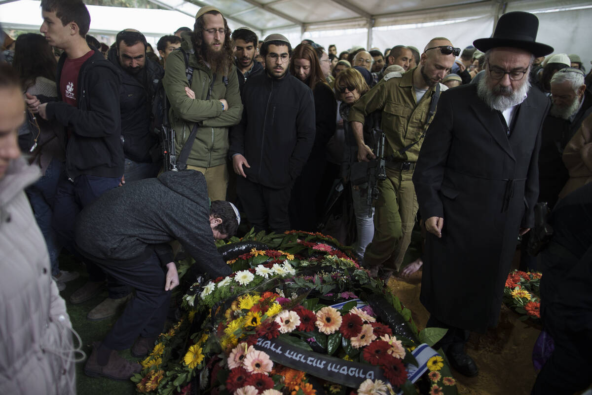 Mourners attend the funeral of Israeli staff sergeant Elisha Yehonatan Lober, who was killed in ...