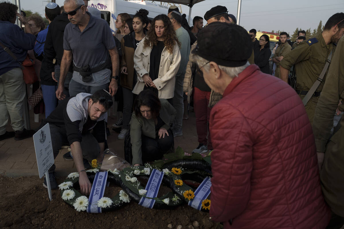Relatives and friends mourn during the funeral of the Israeli Captain Neriya Zisk, at a cemeter ...