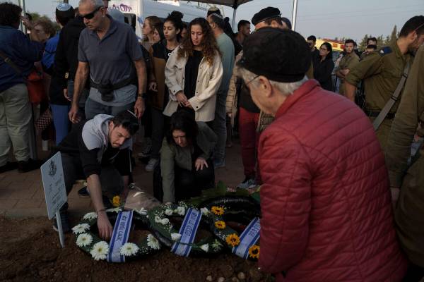 Relatives and friends mourn during the funeral of the Israeli Captain Neriya Zisk, at a cemeter ...
