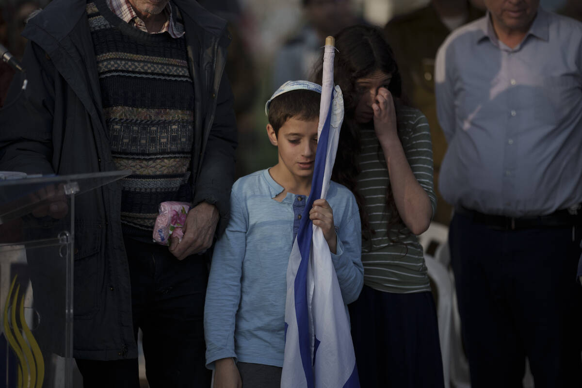 A brother of the Israeli Captain Neriya Zisk mourns during his funeral at a cemetery in the vil ...