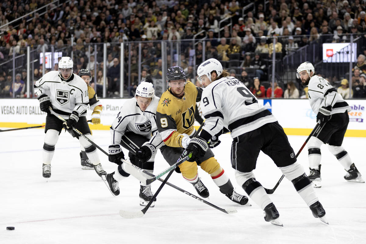 Golden Knights center Jack Eichel (9) passes the puck while Kings defenseman Mikey Anderson (44 ...