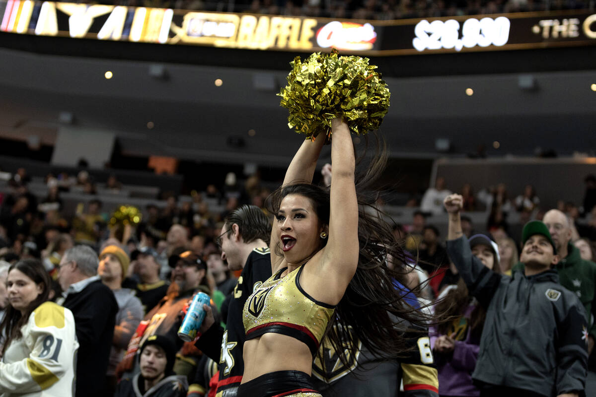 A Golden Knights cheerleader celebrates a goal during the second period of an NHL hockey game a ...