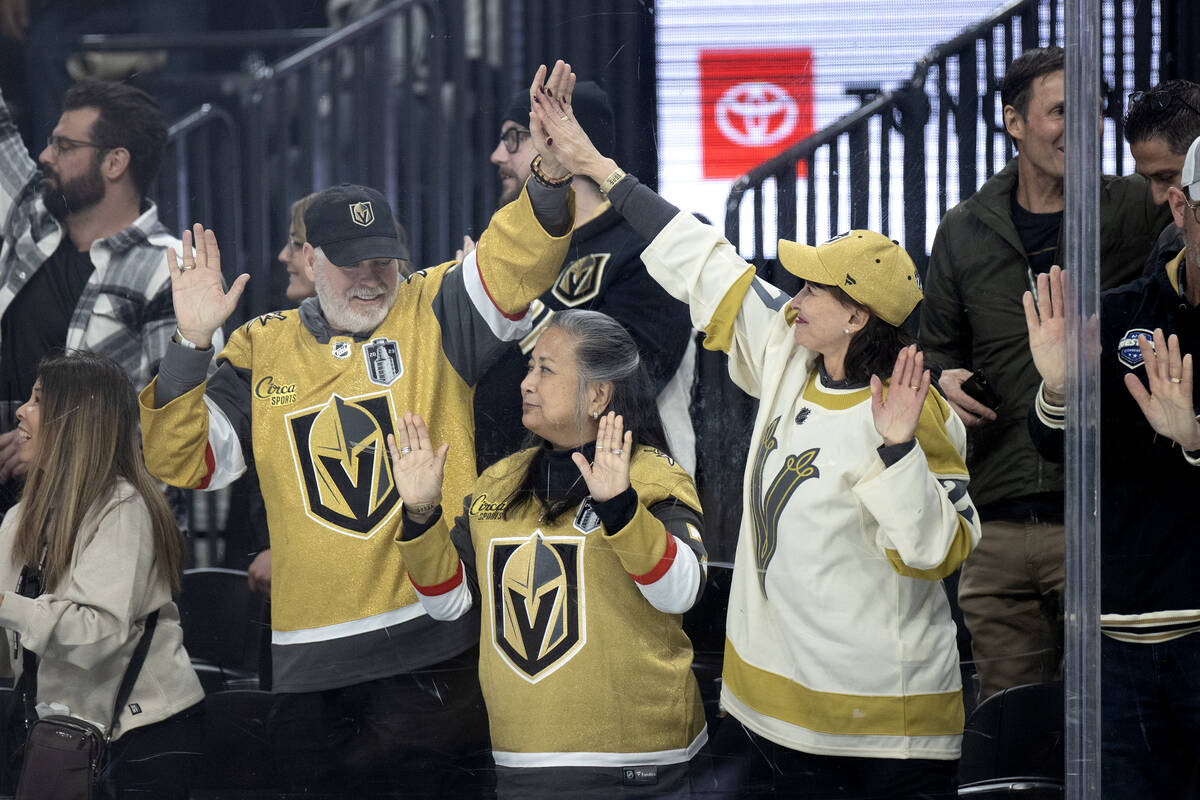 Golden Knights fans celebrate a goal during the second period of an NHL hockey game against the ...