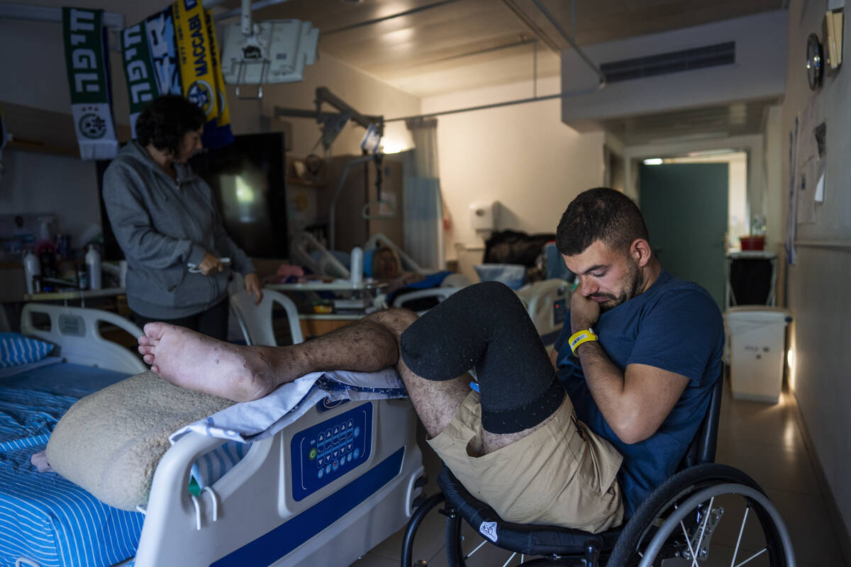 Israeli soldier Jonathan Ben Hamou, 22, wounded in the war with Hamas, sits in his room at Sheb ...