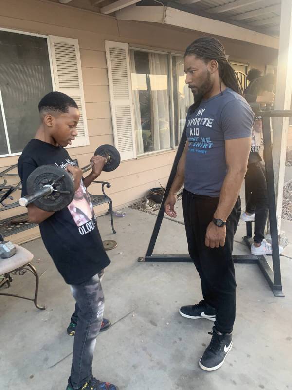 Keon Young, 13, lifting weights with his uncle Robert Cook. (Courtesy of Robert Cook)