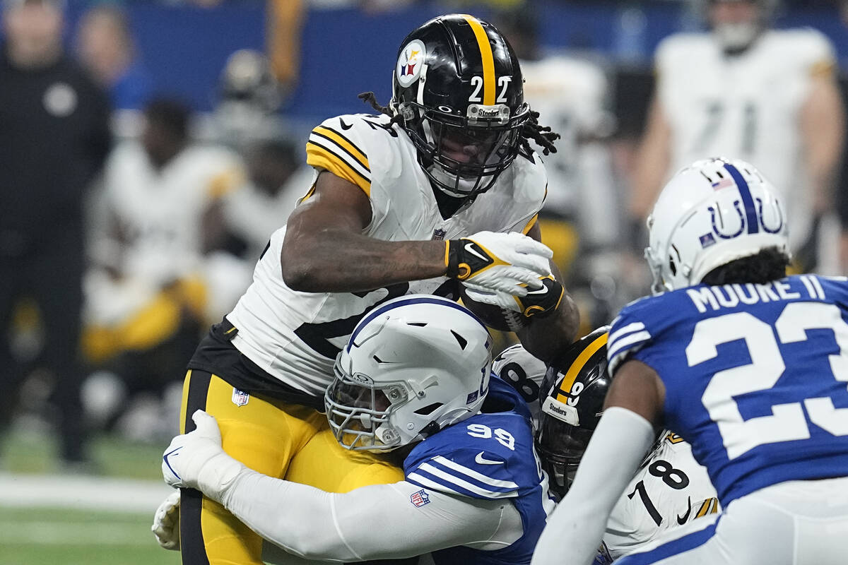 Pittsburgh Steelers running back Najee Harris (22) is tackled by Indianapolis Colts defensive t ...