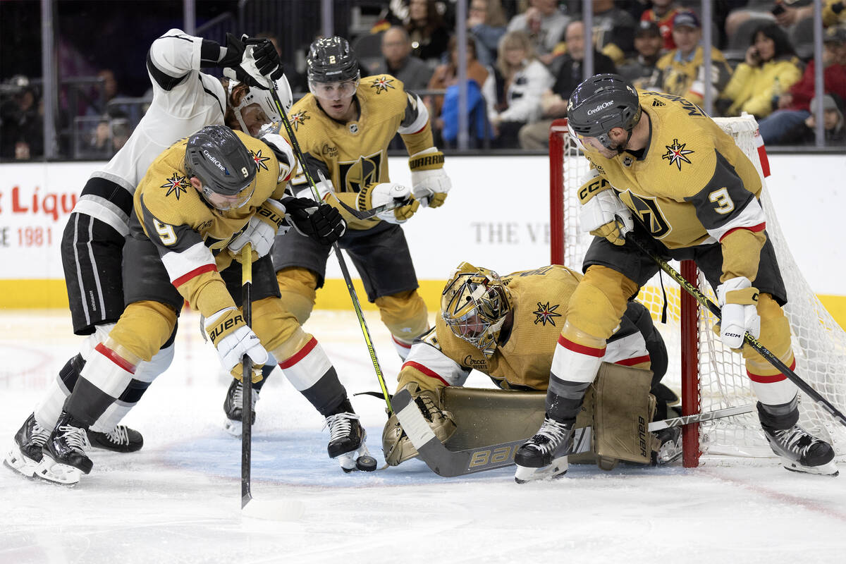 Golden Knights goaltender Logan Thompson (36) saves the puck while center Jack Eichel (9), defe ...