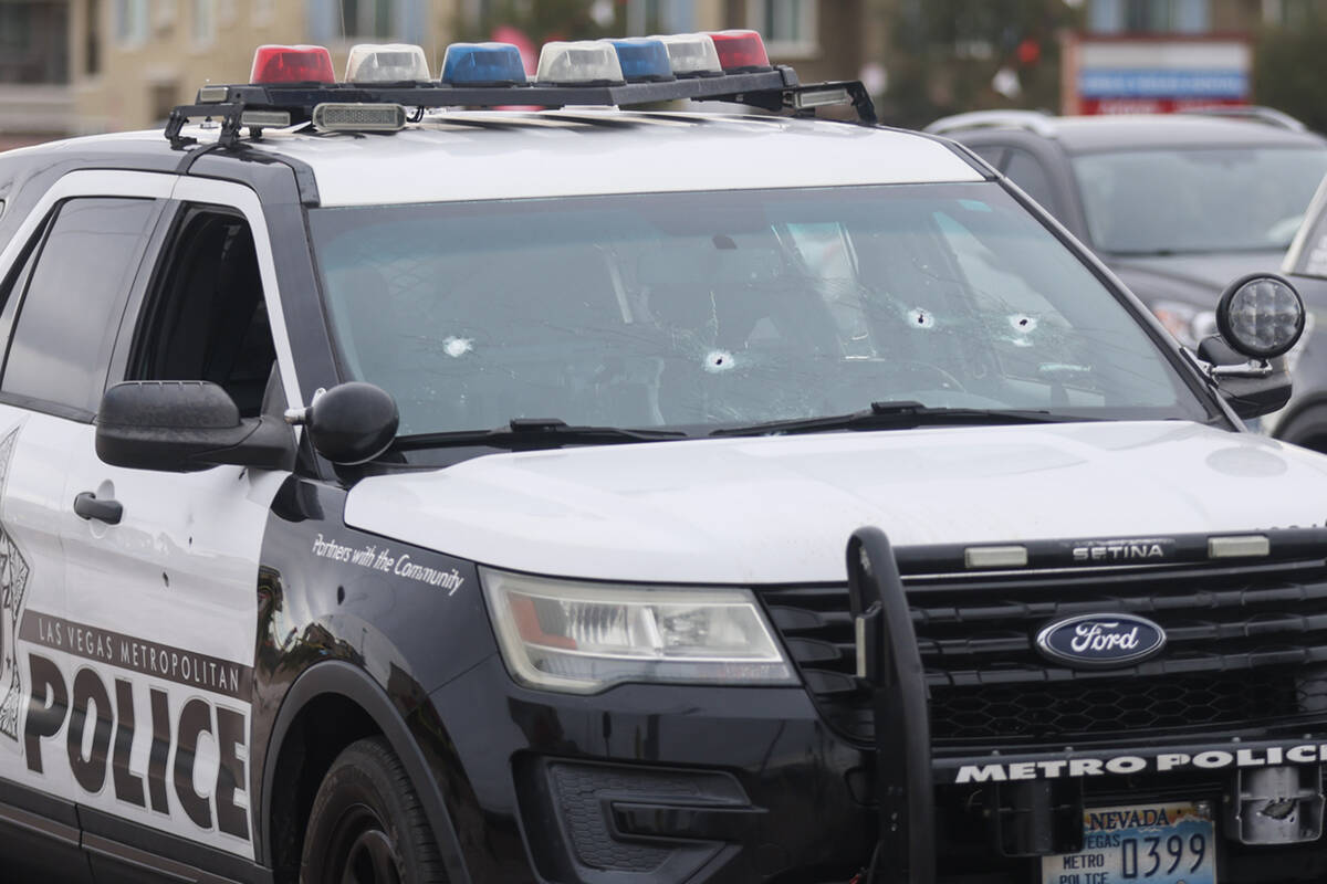 A police car with bullet holes at the scene of an officer involved shooting in the area of Blue ...