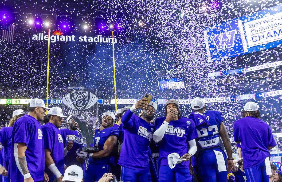 The Washington Huskies celebrate their Pac-12 Football Championship game win against the Oregon ...