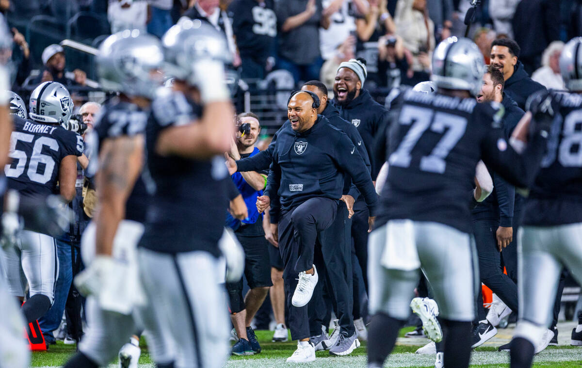 Raiders interim head coach Antonio Pierce and others celebrate a touchdown by defensive tackle ...
