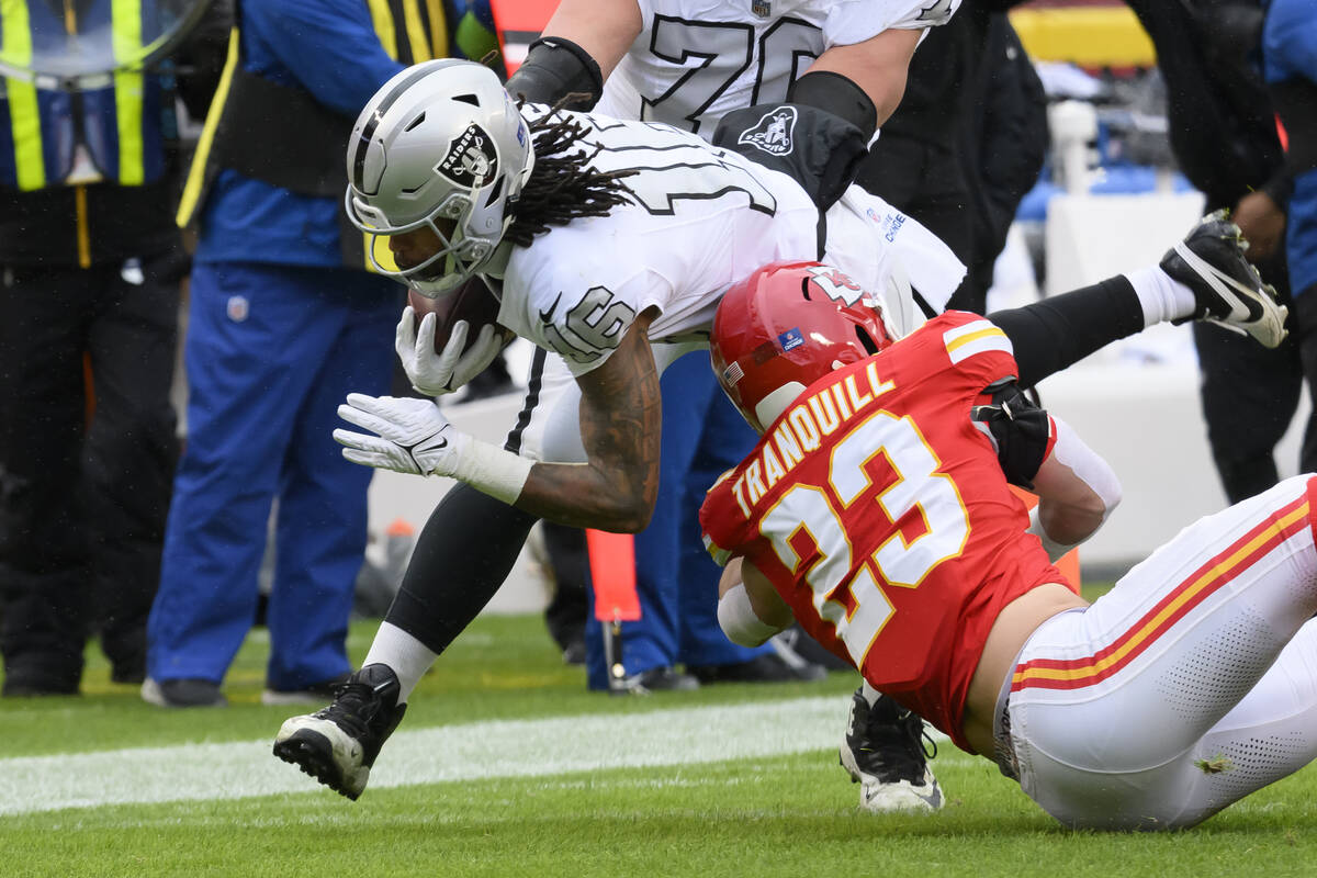 Kansas City Chiefs linebacker Drue Tranquill (23) tackles Las Vegas Raiders wide receiver Jakob ...