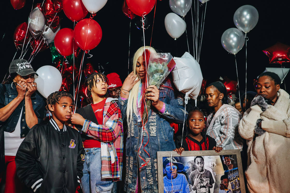 Keonta Cook, middle, the mother of Keon Young, takes a moment before continuing to speak about ...