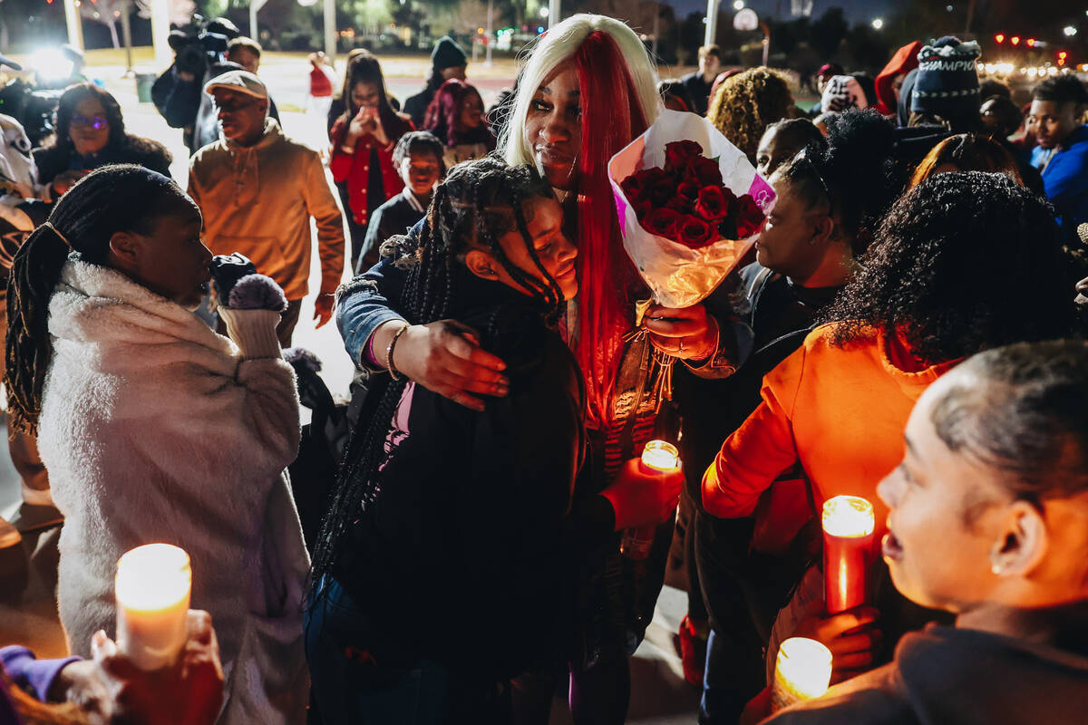 Keonta Cook, the mother of Keon Young, hugs a mourner during a vigil for her son at Desert Hori ...