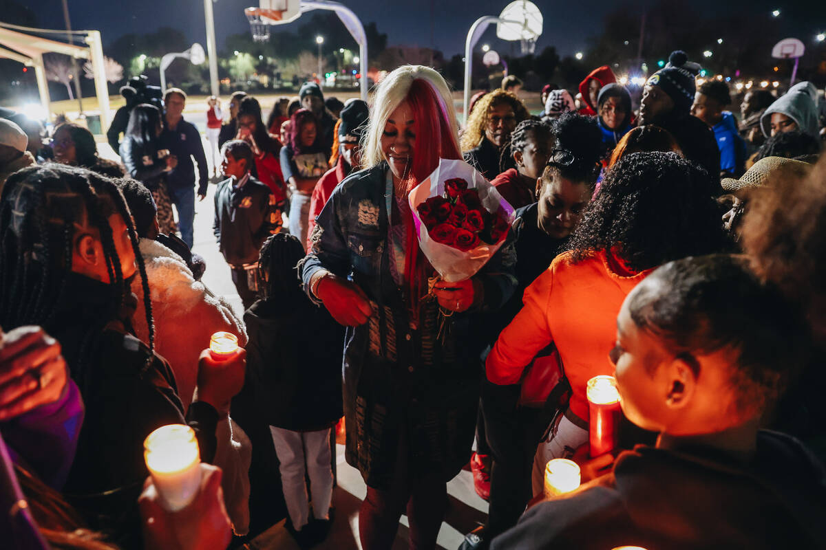 Keonta Cook, the mother of Keon Young, walks towards a group of mourners during a vigil for her ...