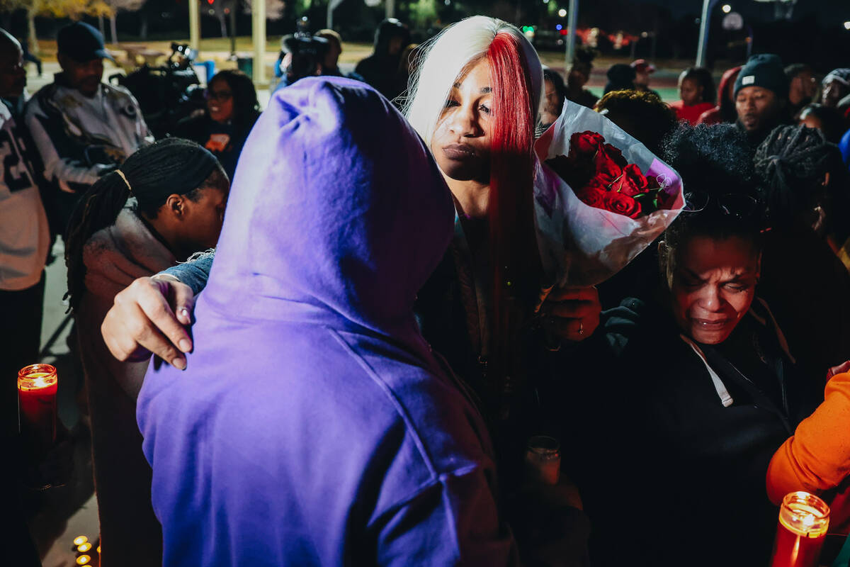 Keonta Cook, the mother of Keon Young, hugs a mourner during a vigil for her son at Desert Hori ...