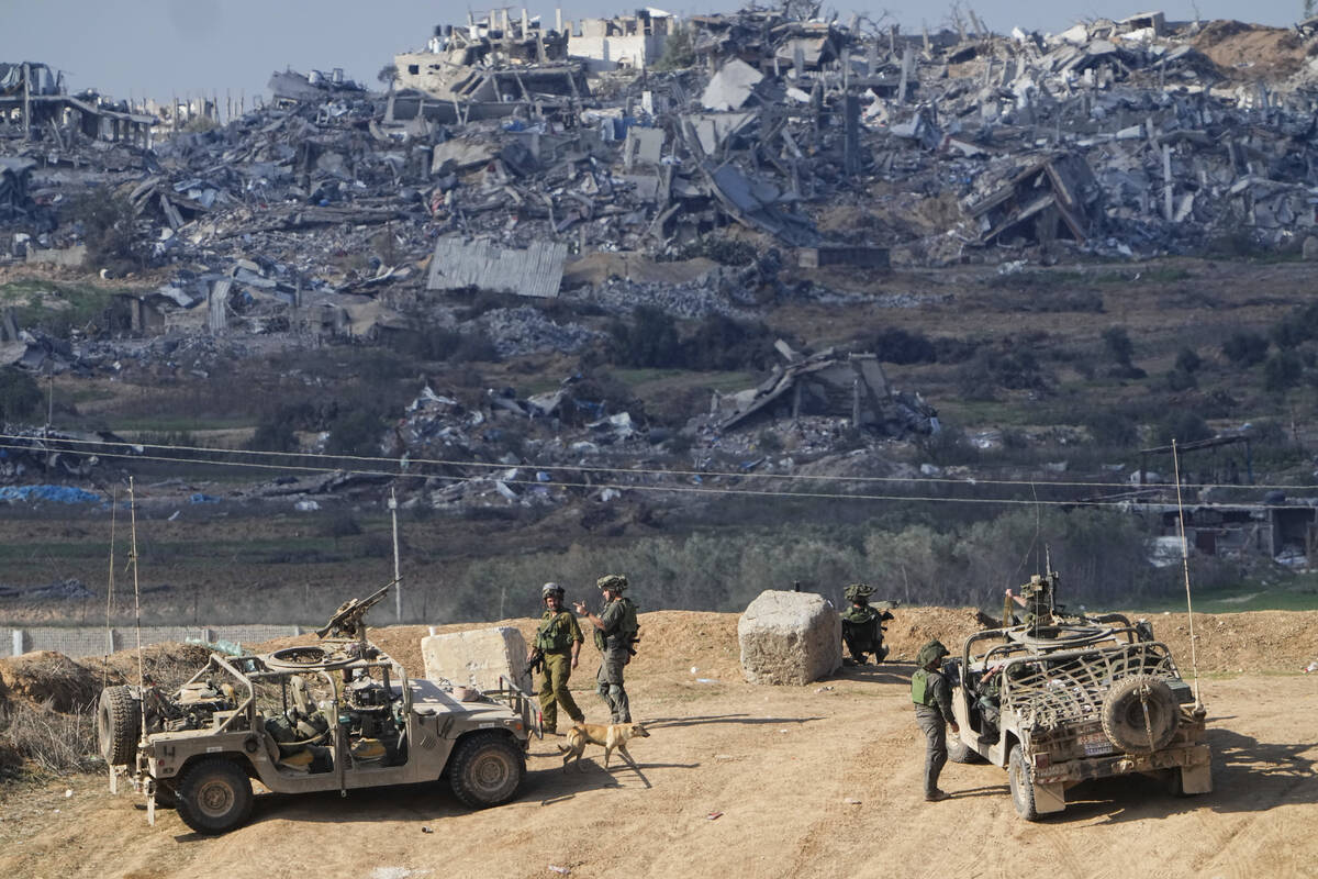 Israeli soldiers take up positions near the Gaza Strip border, in southern Israel, Friday, Dec. ...