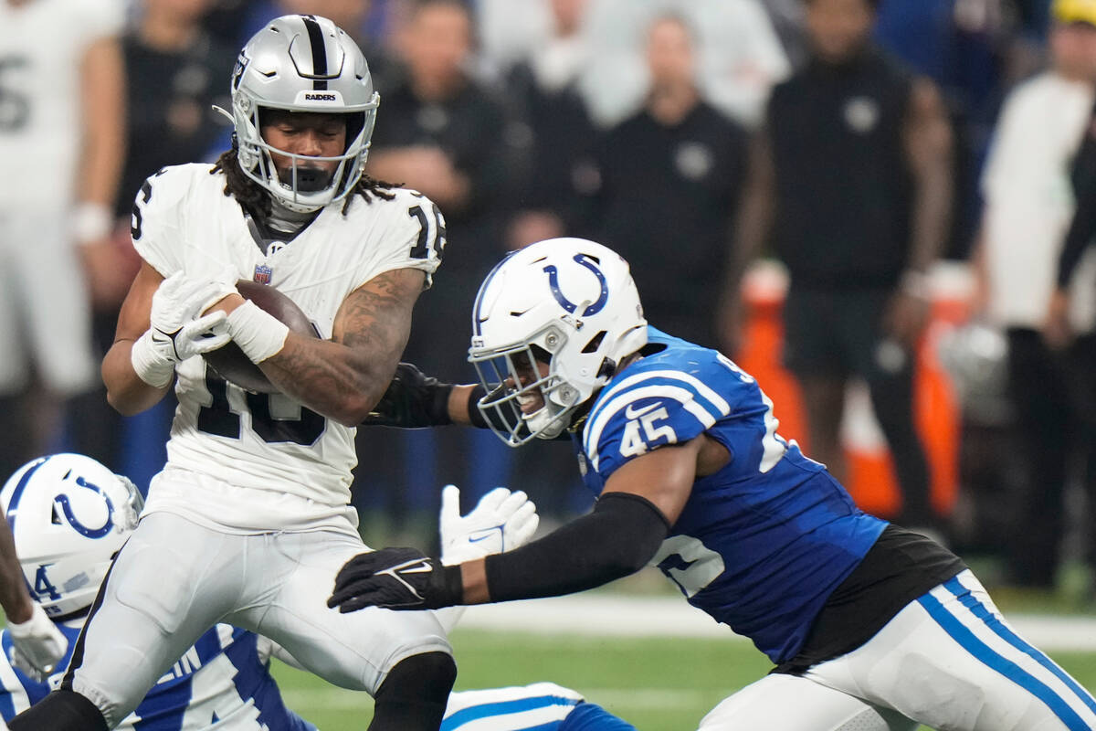 Las Vegas Raiders wide receiver Jakobi Meyers (16) is tackled by Indianapolis Colts linebacker ...