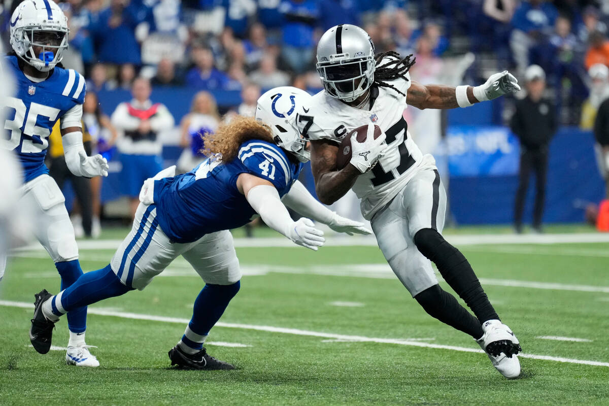 Las Vegas Raiders wide receiver Davante Adams (17) runs past Indianapolis Colts linebacker Gran ...