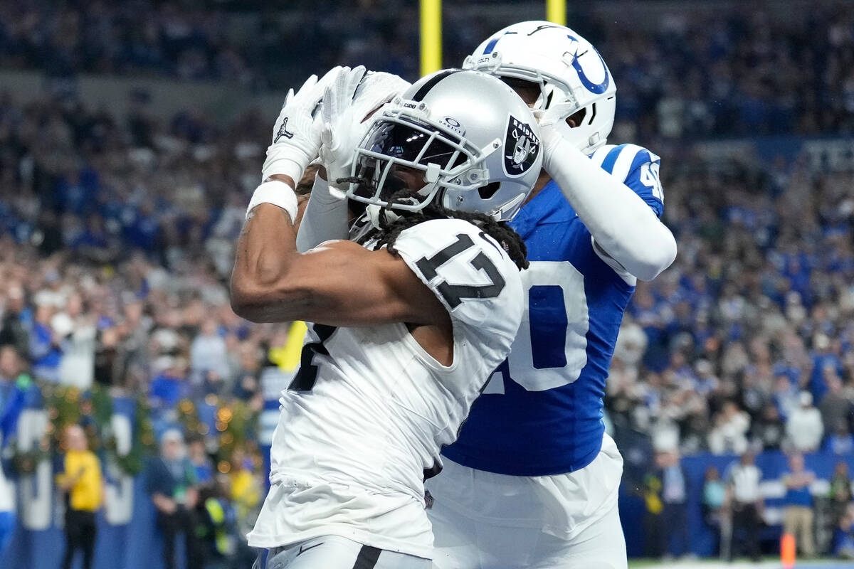 Las Vegas Raiders wide receiver Davante Adams (17) makes a touchdown catch past Indianapolis Co ...