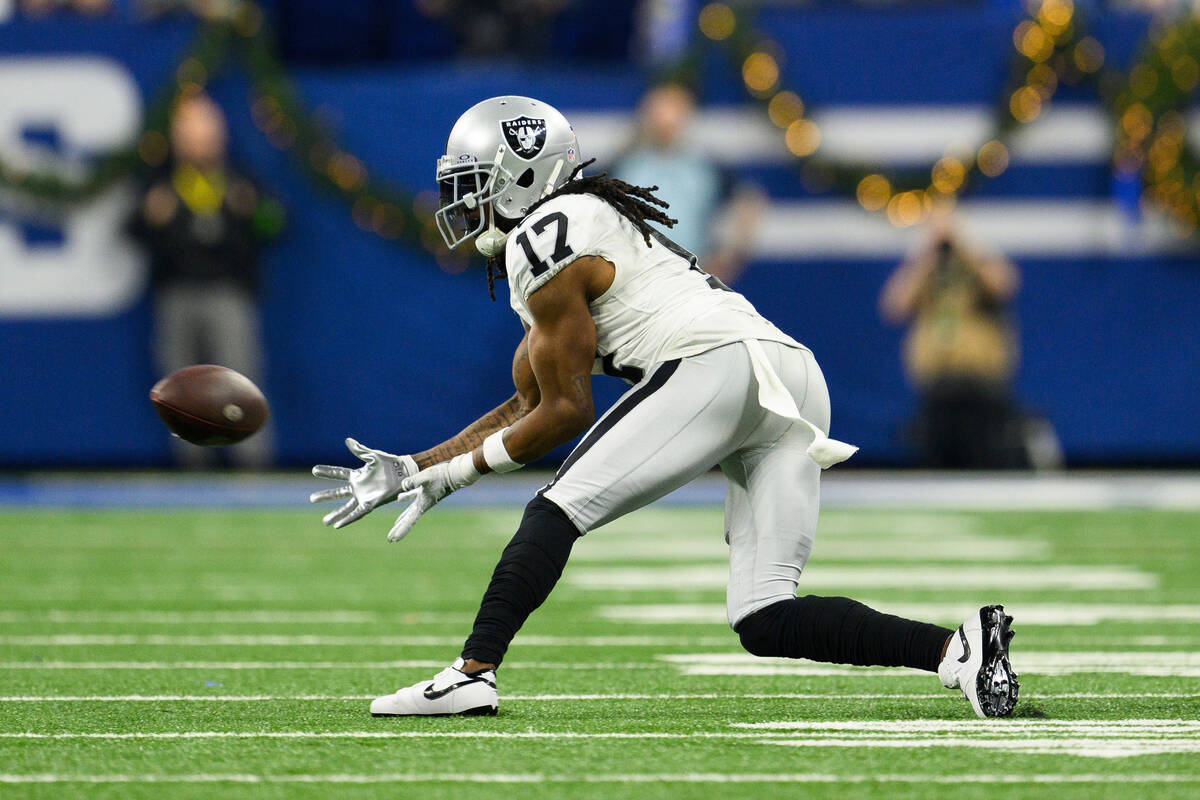 Las Vegas Raiders wide receiver Davante Adams (17) reaches out for a pass during an NFL footbal ...