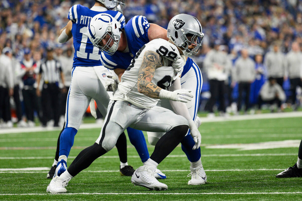 Las Vegas Raiders defensive end Maxx Crosby (98) rushes around Indianapolis Colts tackle Bernha ...