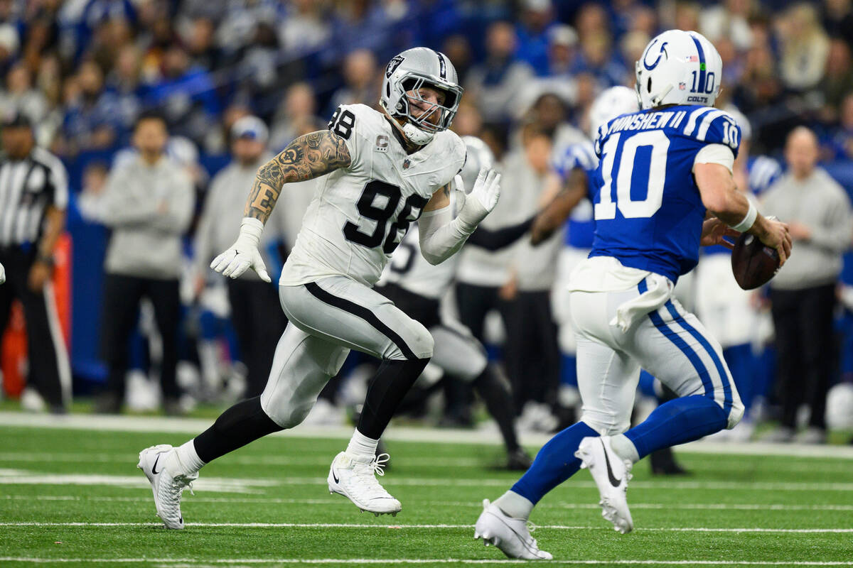 Las Vegas Raiders defensive end Maxx Crosby (98) gets pressure on Indianapolis Colts quarterbac ...