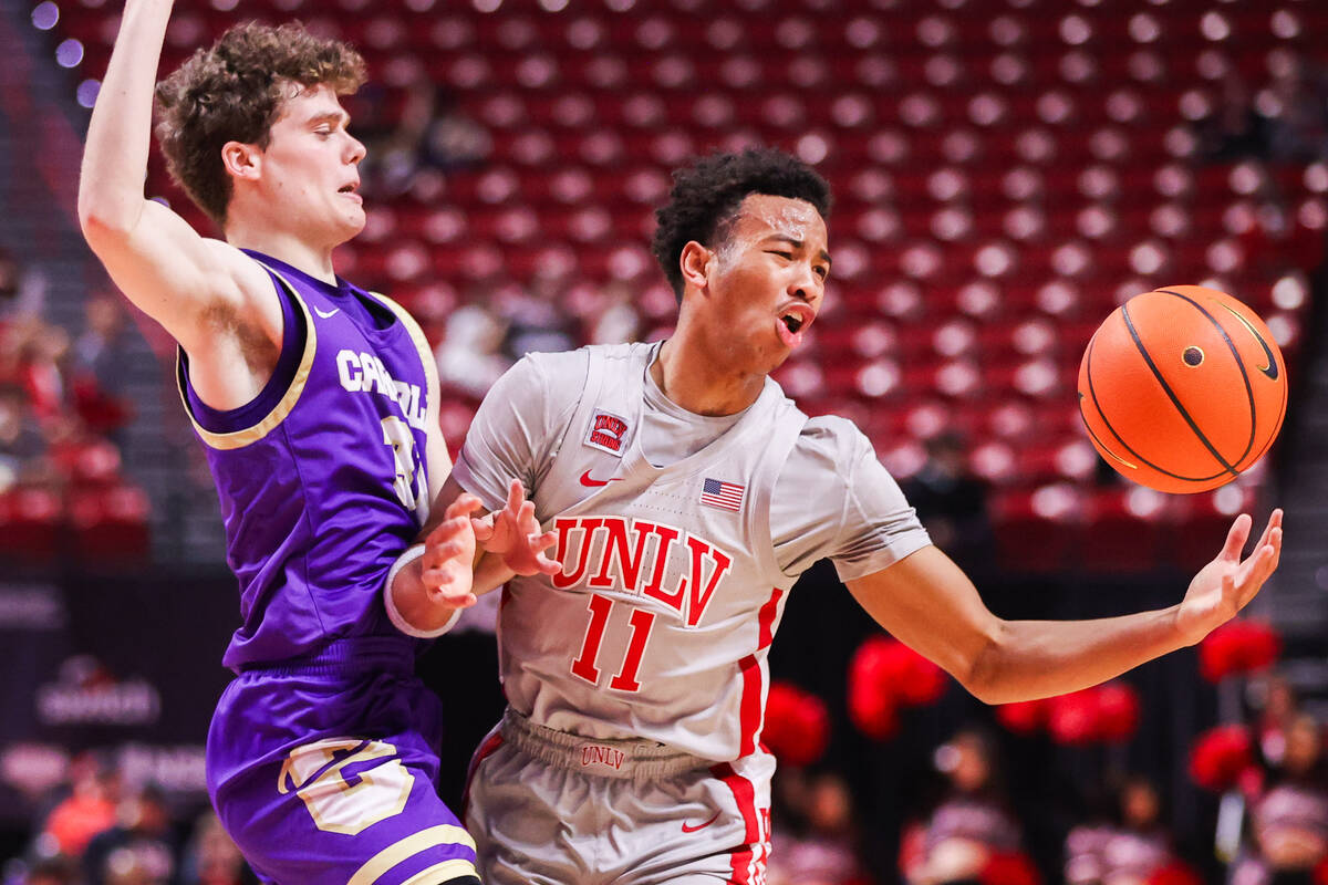 Carroll College Fighting Saints guard James Lang (31) pressures UNLV Rebels guard Dedan Thomas ...