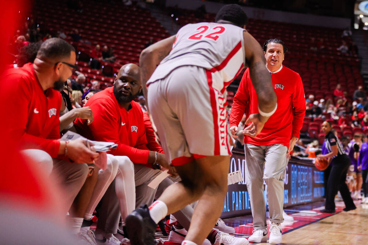 UNLV Assistant Coach Barret Peery prepares to bring in UNLV Rebels forward Karl Jones (22) duri ...