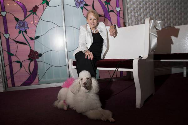 Charolette Richards, owner of A Little White Wedding, with her dog at her Las Vegas business, W ...
