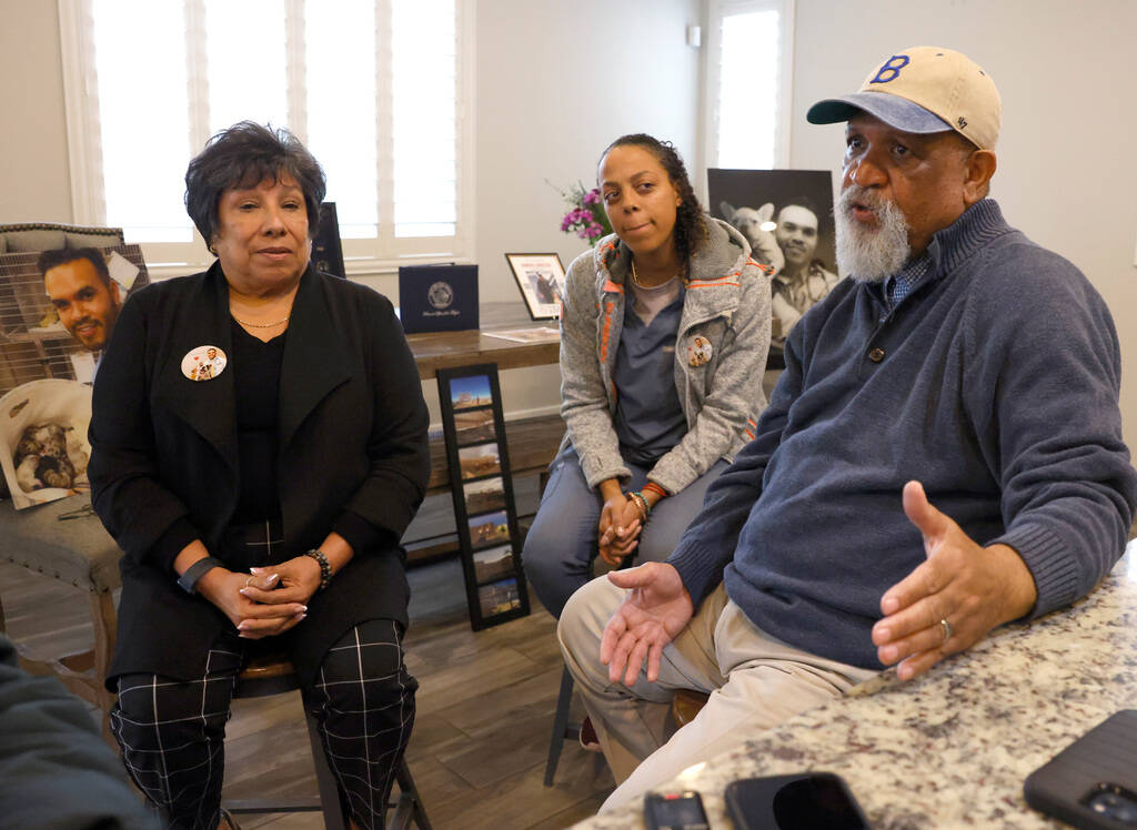 Tonnie Bivens, right, the father of Dr. Aaron Bivens, speaks about his son as his wife, Susan H ...