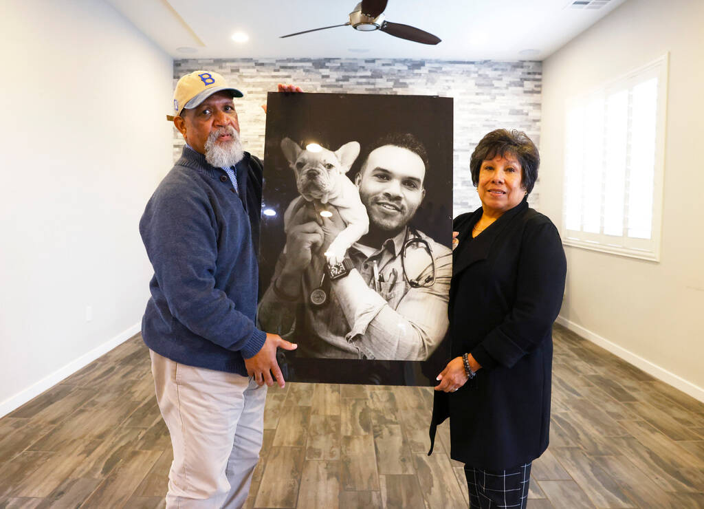 Tonnie Bivens and his wife, Susan Hernandez, hold a photograph of their late son Dr. Aaron Bive ...