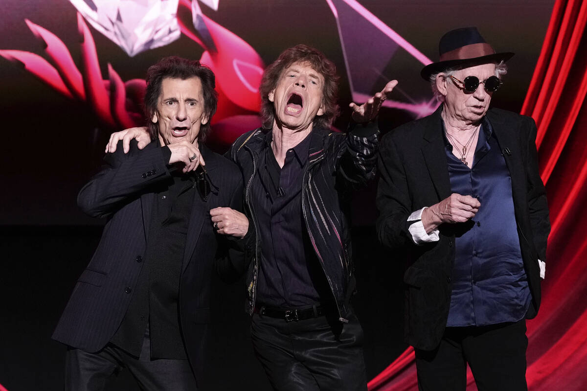 Ronnie Wood, from left, Mick Jagger, and Keith Richards pose for photographers at the press con ...