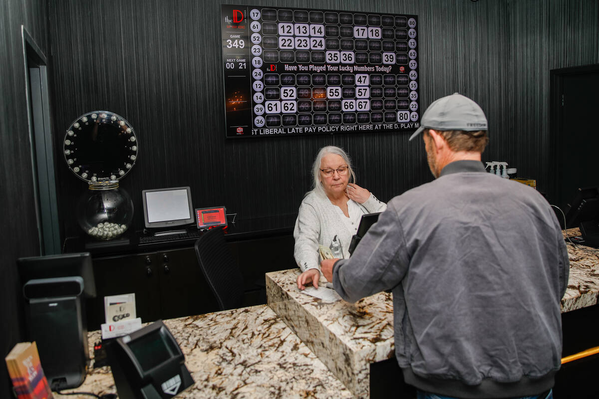 Nancy, who has worked keno at The D for 18 years, helps out a customer at the Keno Lounge in Th ...