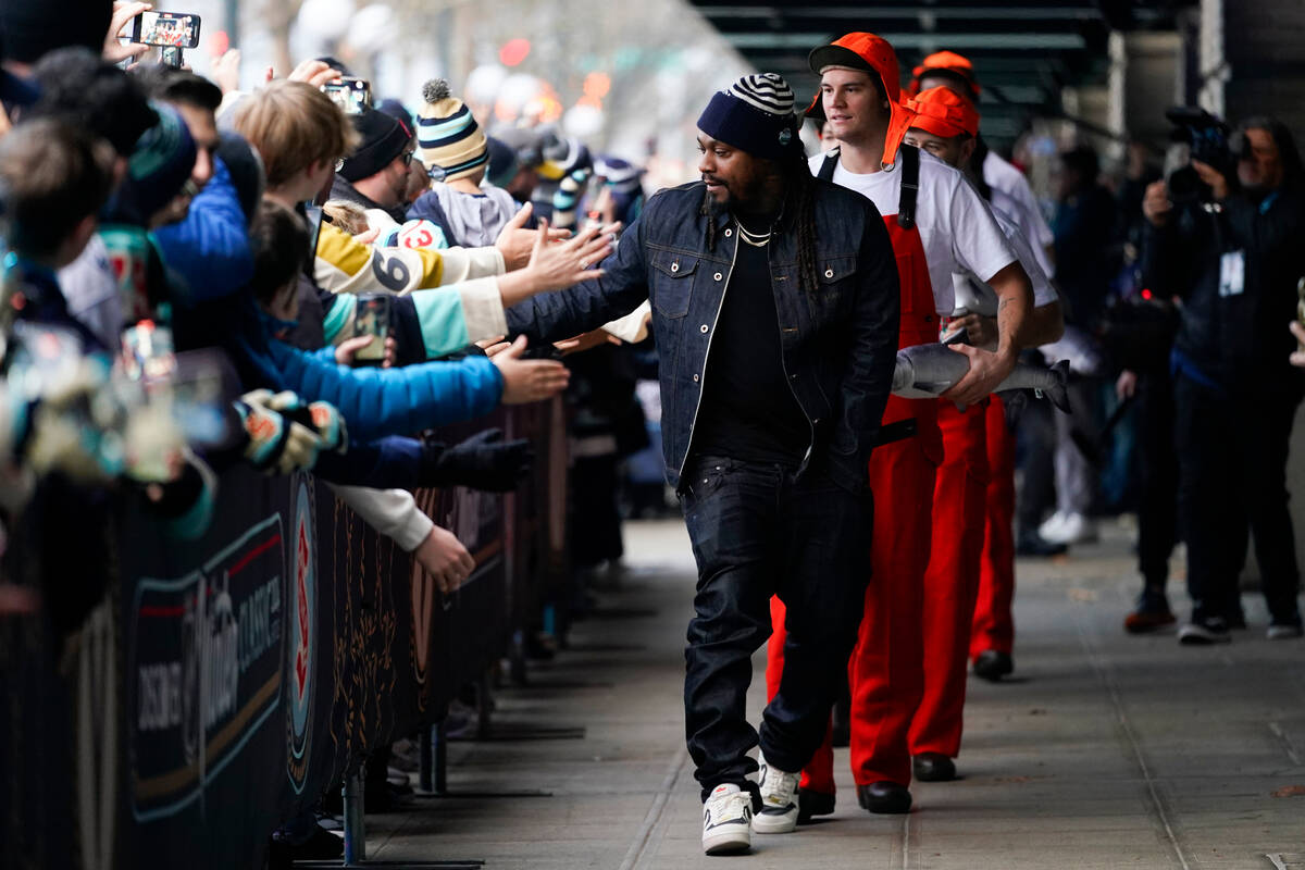 Former Seattle Seahawks running back Marshawn Lynch greets fans as he arrivers with the Seattle ...