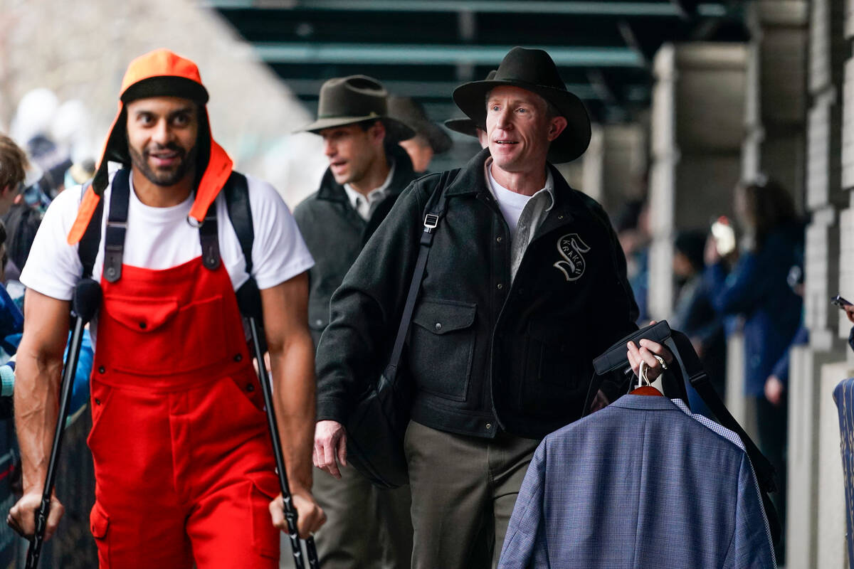 Seattle Kraken head coach Dave Hakstol, right, arrives with left wing Pierre-Edouard Bellemare, ...