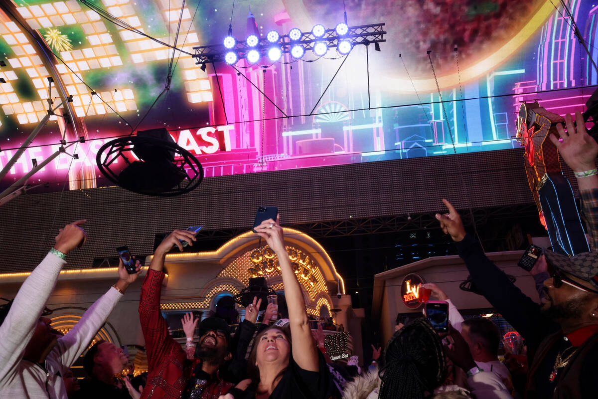 New Year’s Eve revelers, including Tanea Spooner Jacksonville, Fla., center, watch the ...