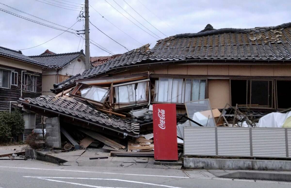 A house is damaged by an earthquake in Wajima, Ishikawa prefecture, Japan Monday, Jan. 1, 2024. ...