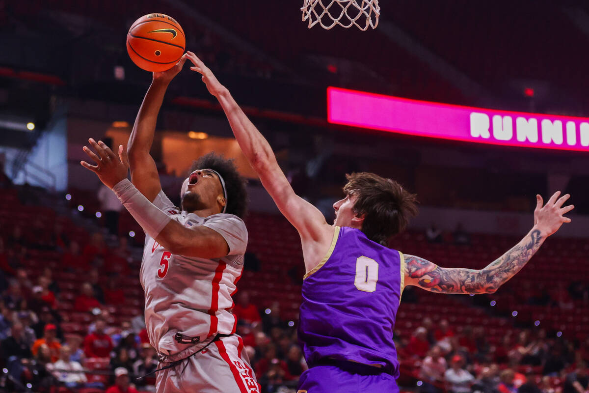 UNLV Rebels forward Rob Whaley Jr. (5) shoots a layup around Carroll College Fighting Saints ce ...