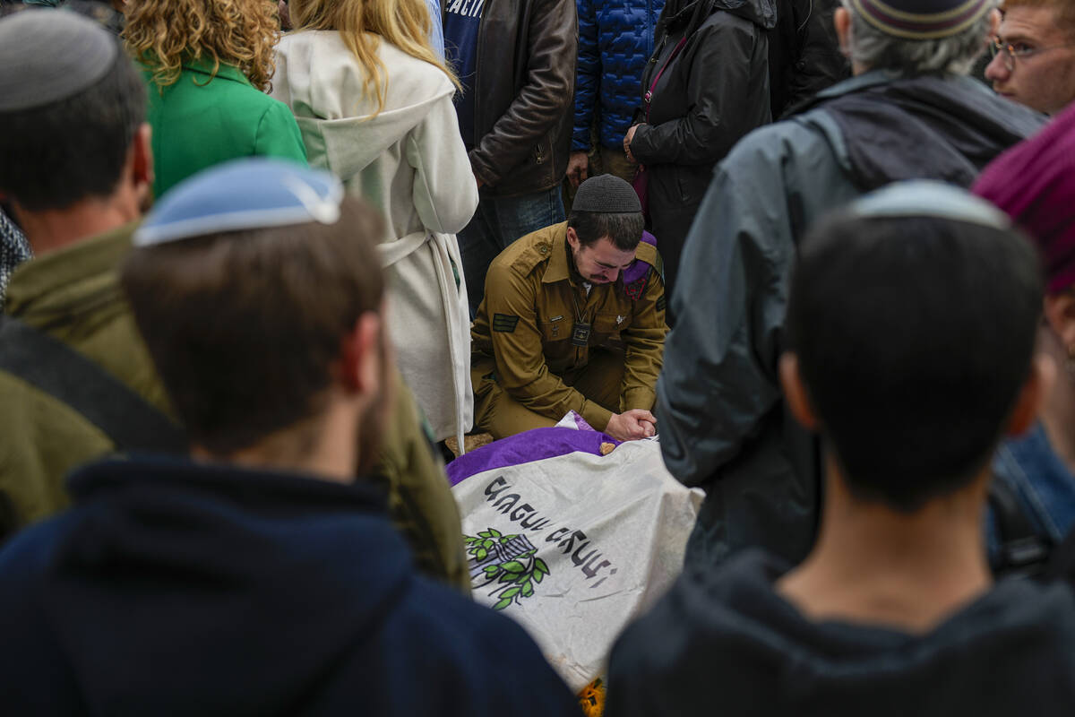 Mourners gather in grief around the grave of American-Israeli reserve solider Sgt. 1st Class Am ...