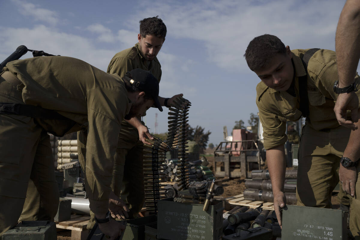 Israeli soldiers store ammunition in a staging area at the Israeli-Gaza border in southern Isra ...