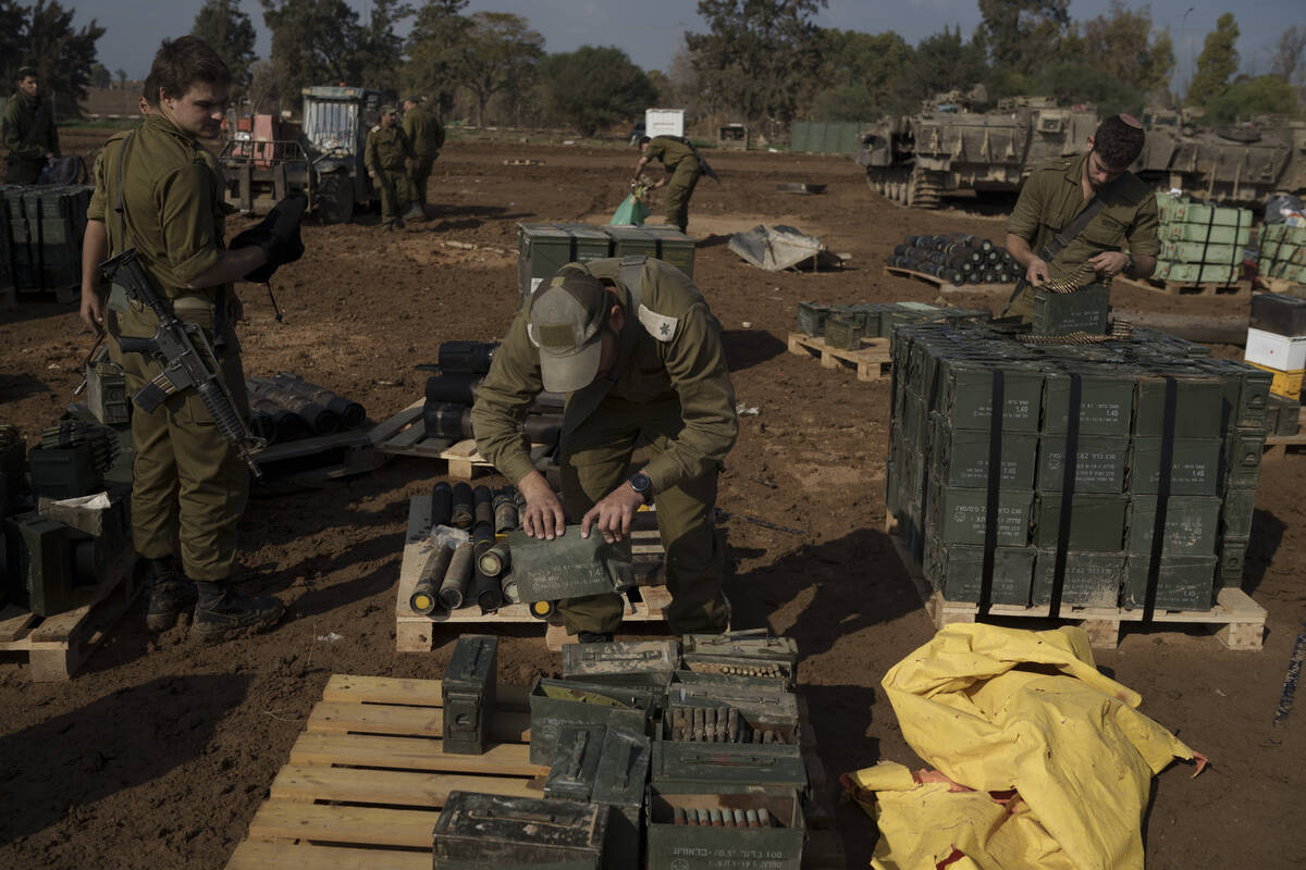 Israeli soldiers store ammunition in a staging area at the Israeli-Gaza border in southern Isra ...