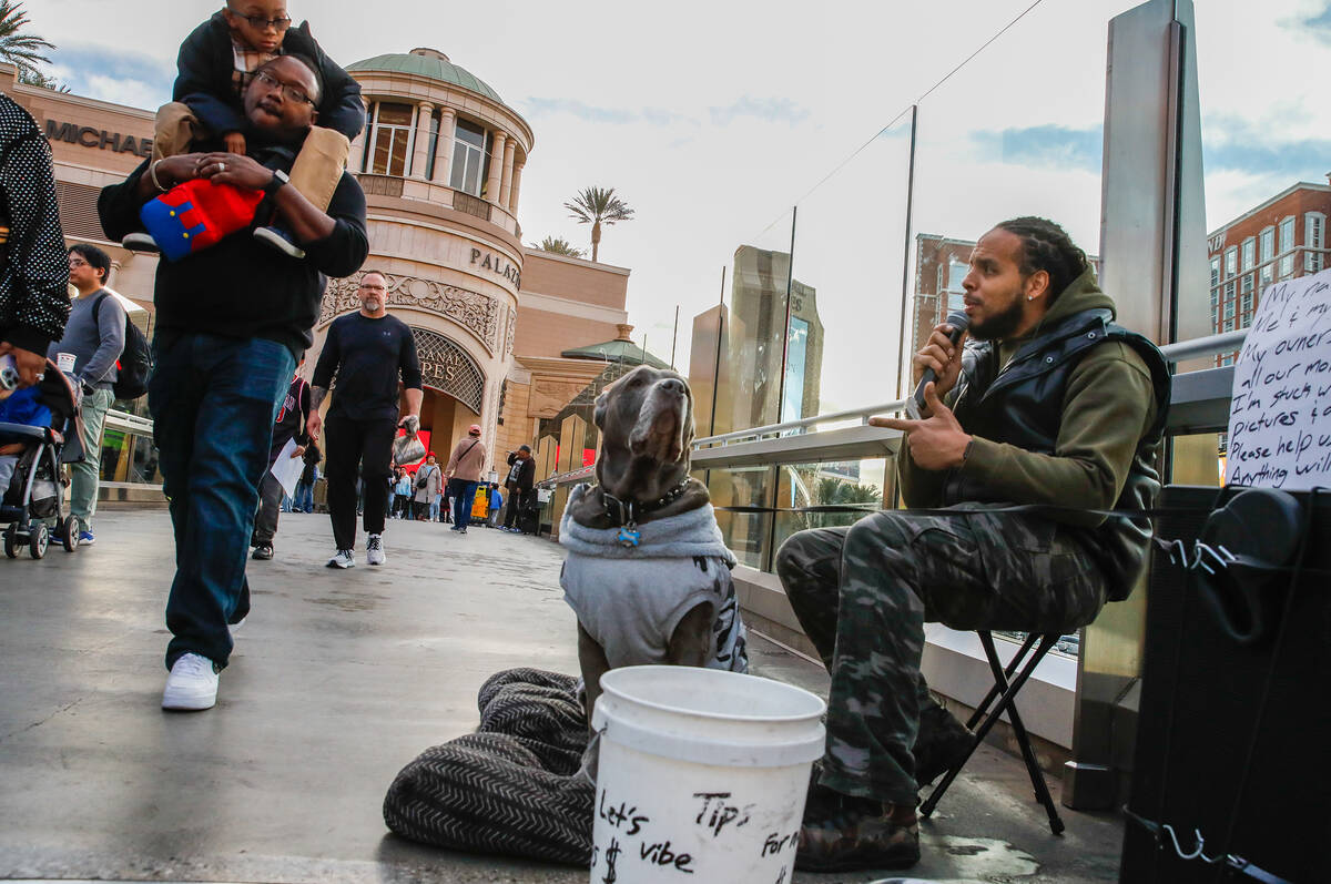 Joel Upia sings alongside his dog on a pedestrian bridge that crosses over Sands Avenue on Tues ...