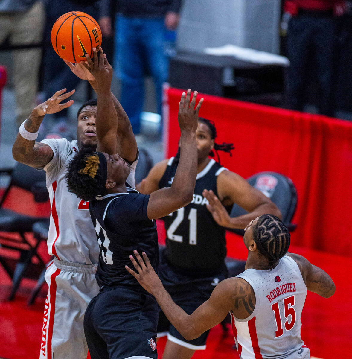 UNLV Rebels forward Karl Jones (22) rejects a shot by Bethesda University Flames forward Jonath ...