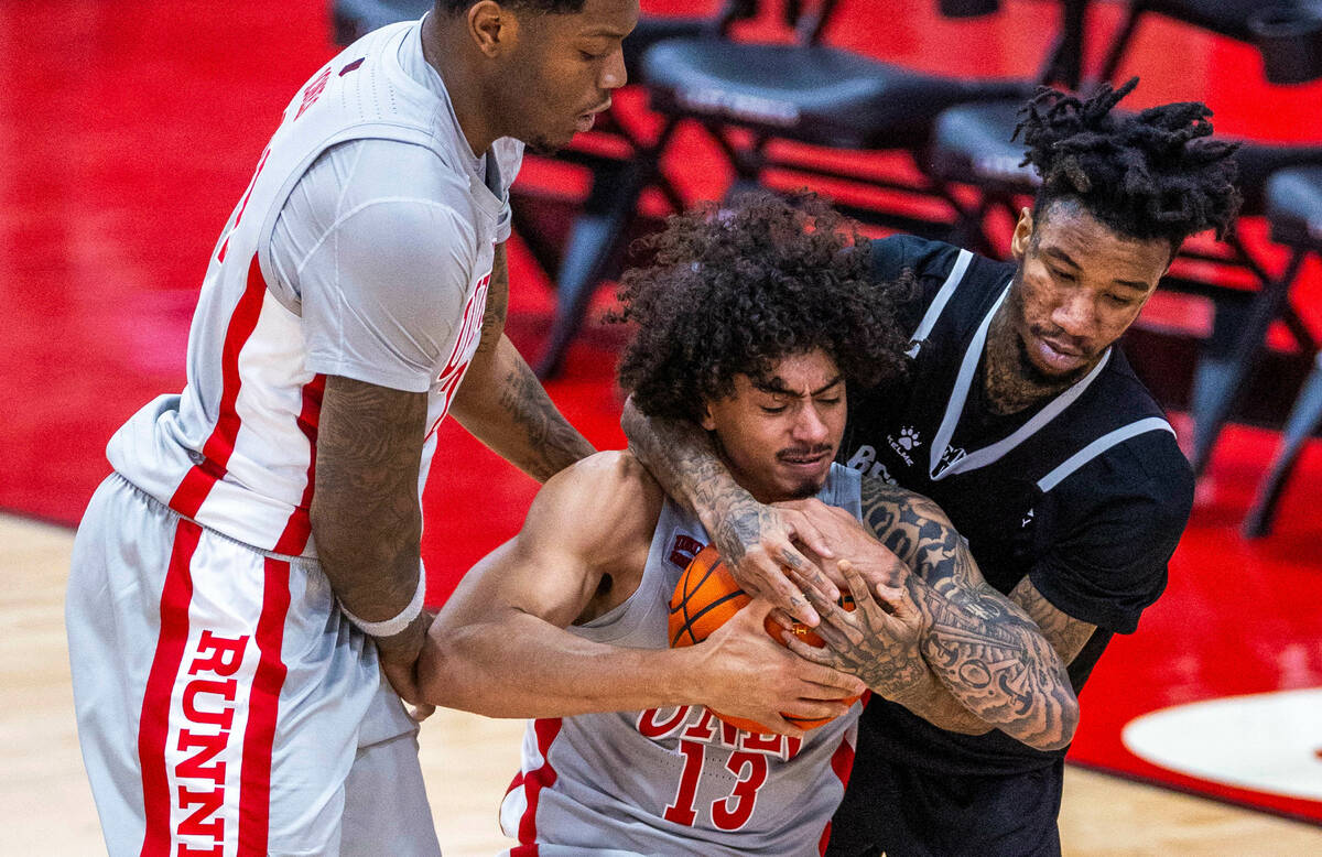 UNLV Rebels guard Brooklyn Hicks (13) is fouled from behind by Bethesda University Flames guard ...