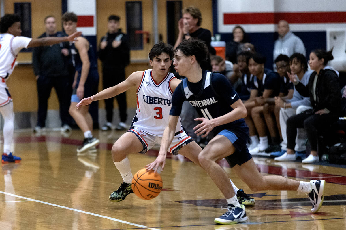 Centennial guard Jaxon Price (11) dribbles against Liberty guard Kaeden Castillero (3) during t ...