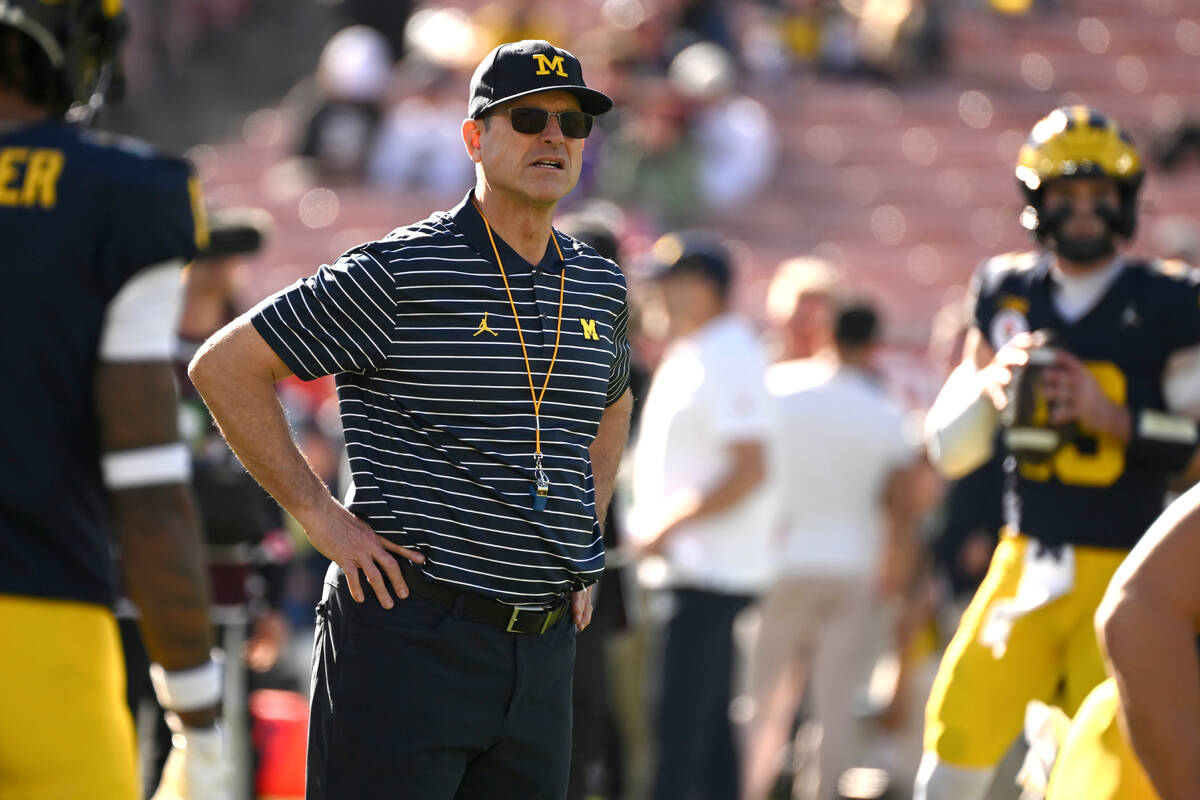 Michigan head coach Jim Harbaugh stands on the field before the Rose Bowl CFP NCAA semifinal co ...