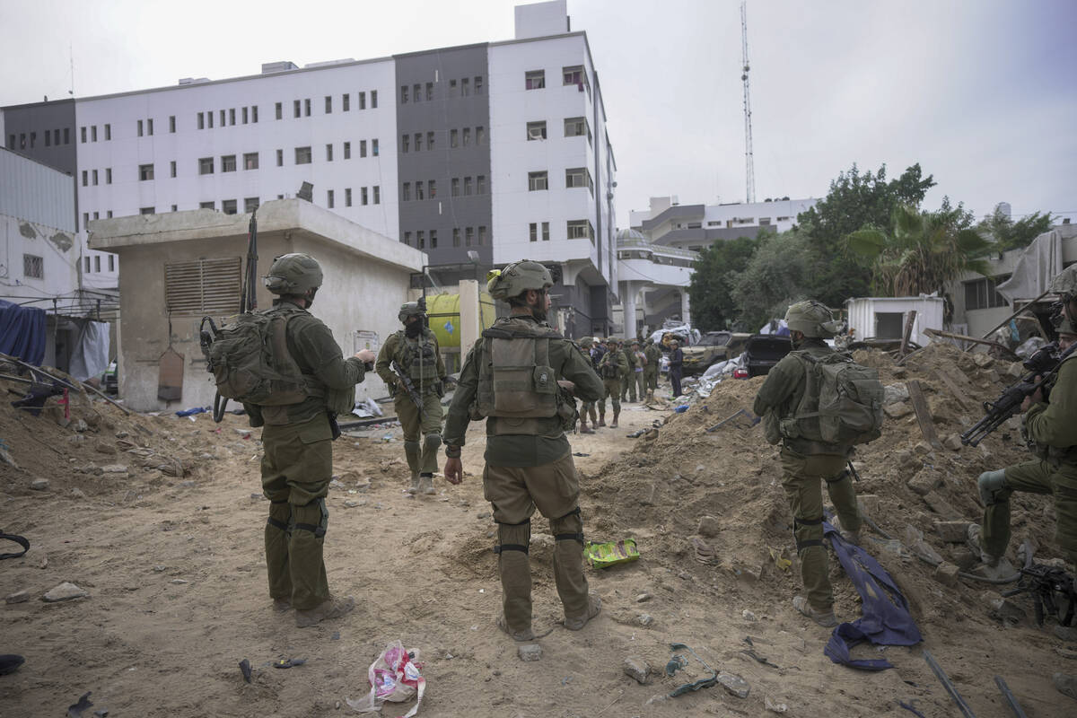 FILE - Israeli soldiers stand outside Shifa Hospital in Gaza City, Nov. 22, 2023. The U.S. is & ...