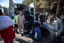 Iranian emergency services arrive at the site where two explosions in quick succession struck a ...